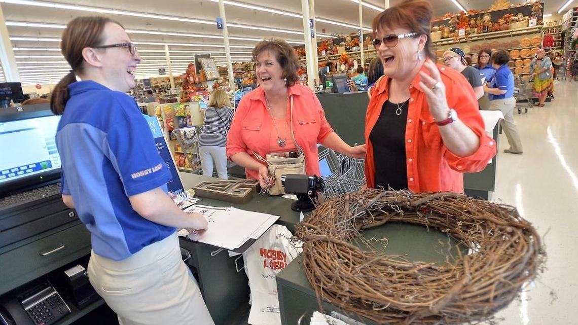 Hobby Lobby cashier Krystal Herrick laughs with customers Valerie McElroy, of Clovis, and Carla Margosian, of Fresno at the Fresno craft and decor store in this 2016 file photo. The median pay for cashiers in Fresno County was $11.04 per hour, according to federal estimates of occupational employment and wages for 2017.