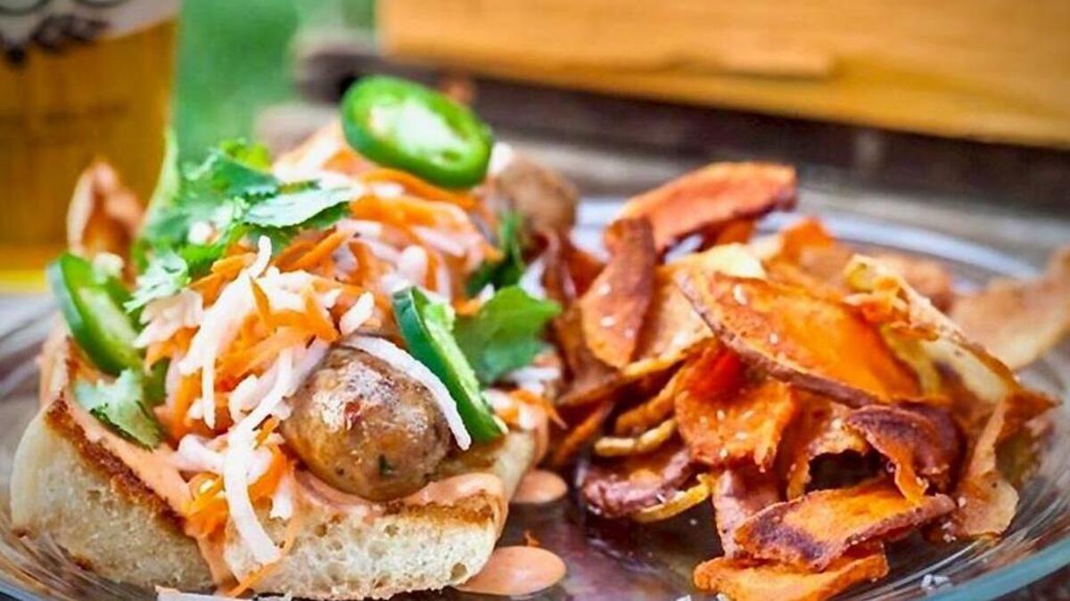 Rocket Dog’s bahn mi dog features a sweet chicken sausage on a toasted baguette with Sriracha mayo, pickled veggies, fresh jalapeños and cilantro. Rocket Dog Gourmet Brats & Brew is closing its Clovis location. 