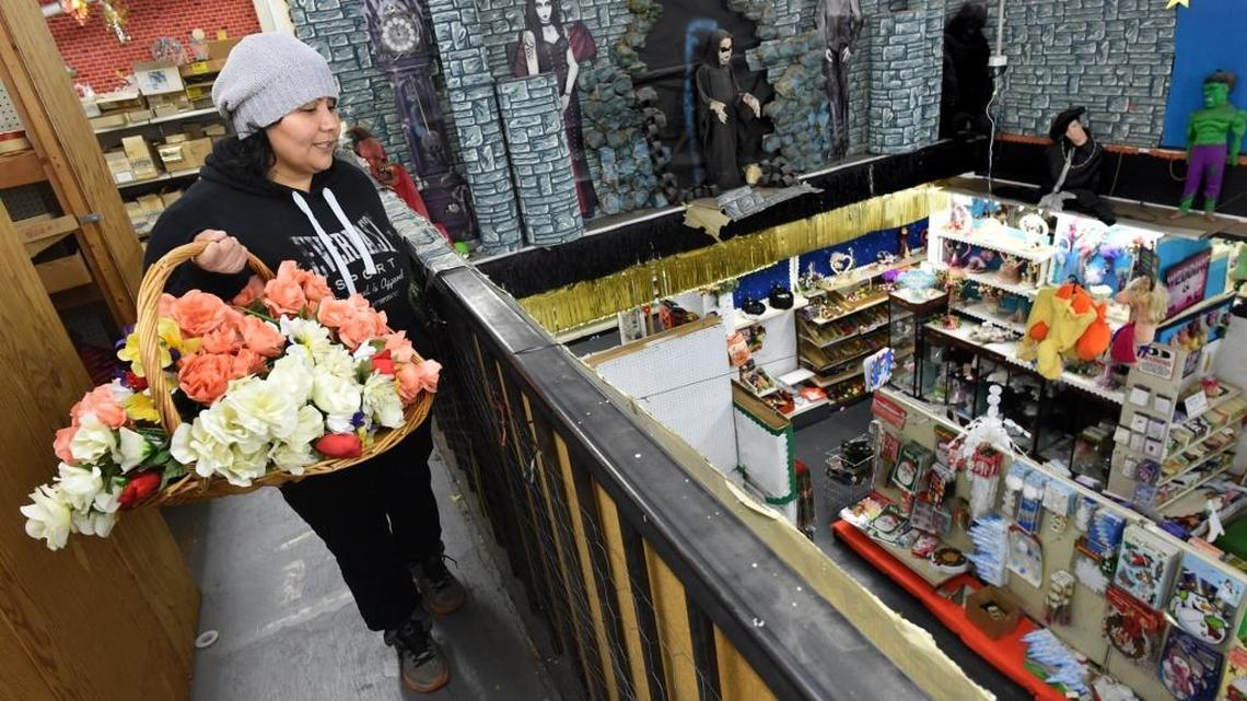 Shopper Carolina Barboza looks down from the second floor as she shops for bargains at Valley Novelty, which is closing after 63 years.