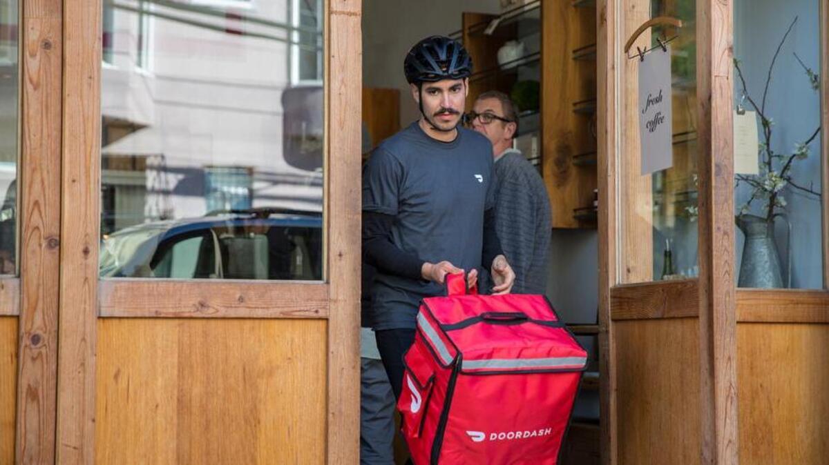A DoorDash delivery person, called a dasher, delivers food from restaurants to customers home. DoorDash started operating in the Fresno area April 18.