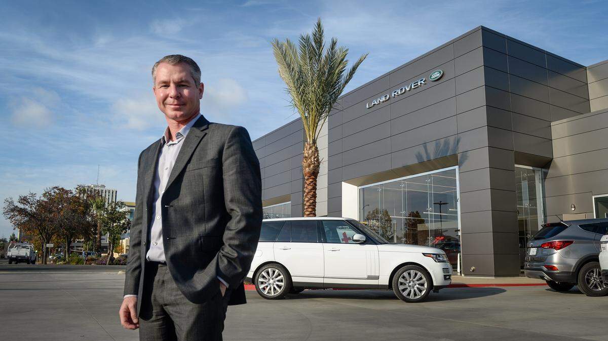 Randy Haron of Haron Jaguar Land Rover stands outside the dealership’s new facility in downtown Fresno in 2019.