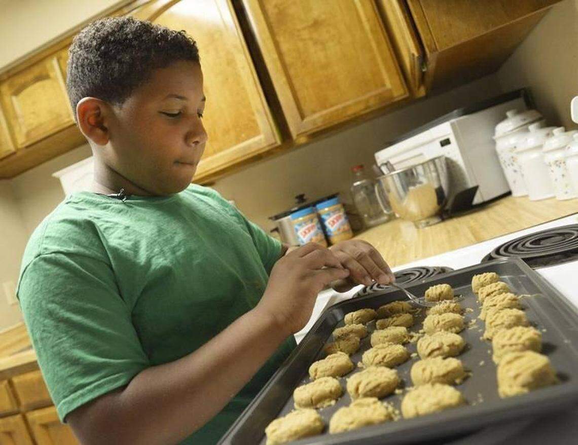 Jalen Bailey, who was 8 in this 2016 photo, prepares a batch of cookies at his family’s home in Fresno. Jalen was at the California Food Expo with his chocolate chip cookies, including gluten-free and vegan versions.