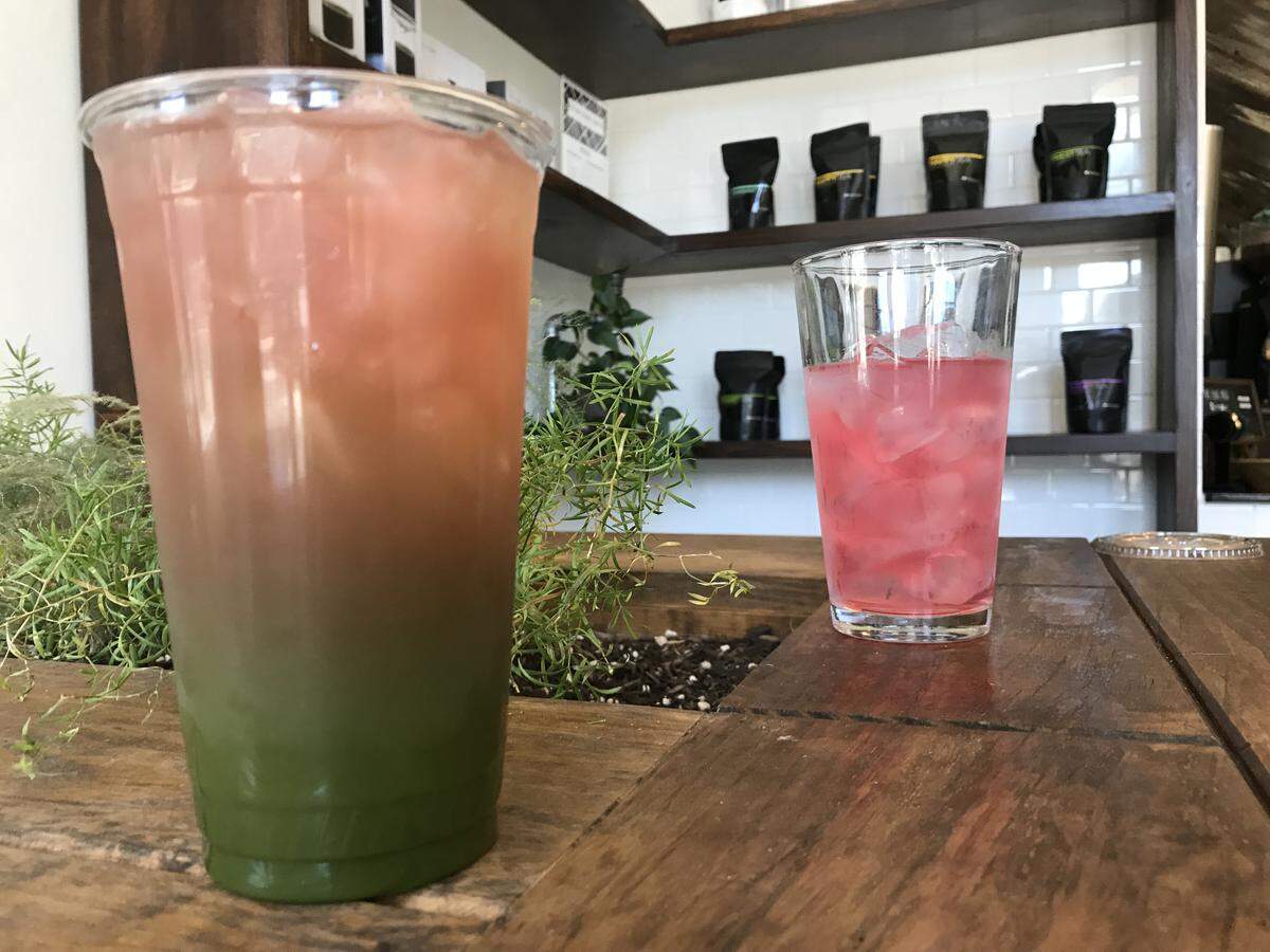 Rose lemonade, in background, is made by brewing rose petals with lemon juice and sugar, at Fulton Street Coffee. The business is both a tea and coffee bar. In foreground, the rose lemonade has been added to a shot of matcha tea.