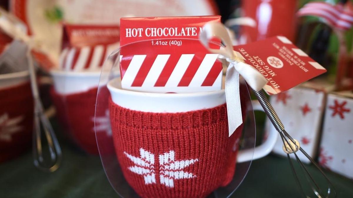 Hot chocolate gift set including its own cozy sweater and whisk at Bullard Pharmacy.