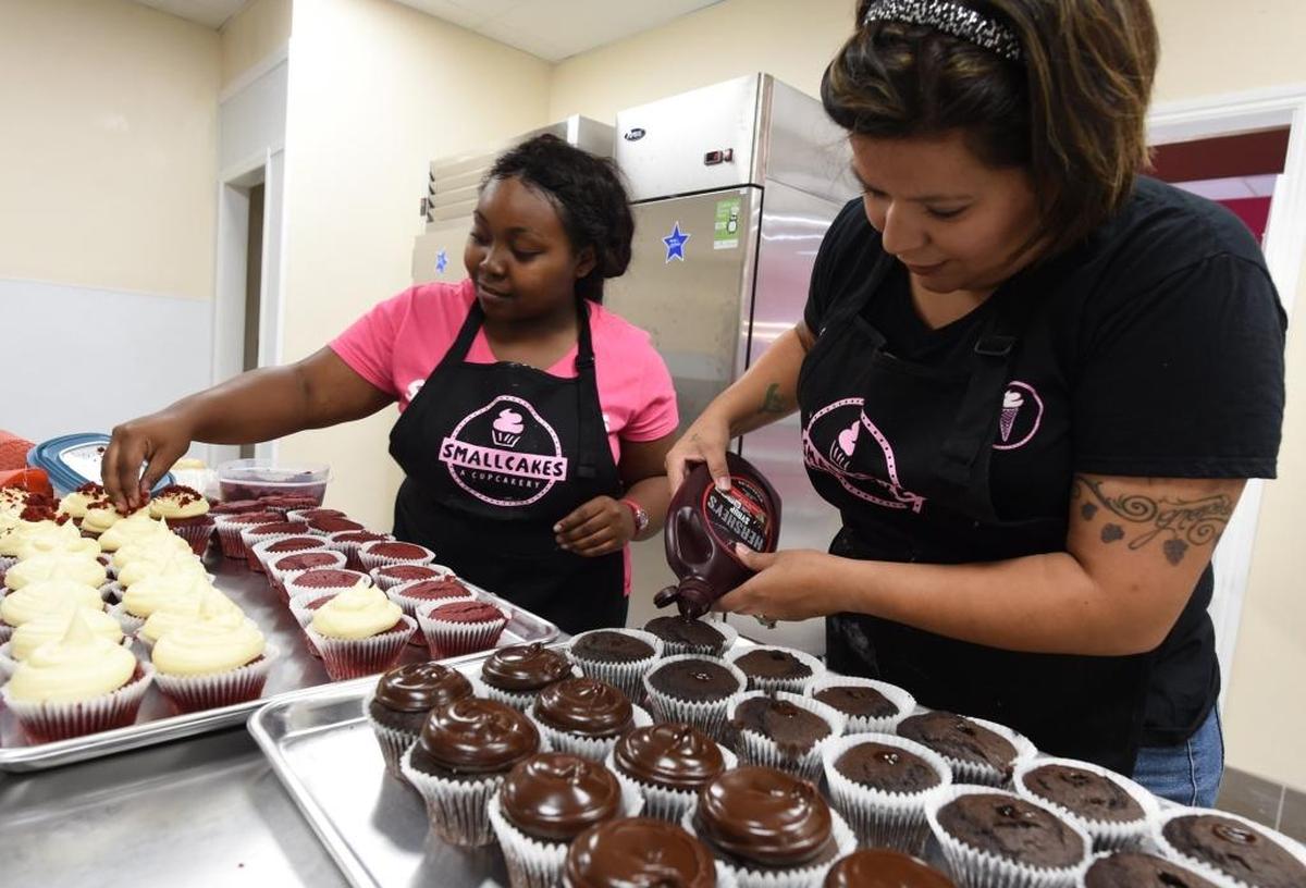 Where the cupcake magic takes place – the kitchen of Smallcakes. Ayrin Riley, left, and Leticia Juarez, make the sweet treats.