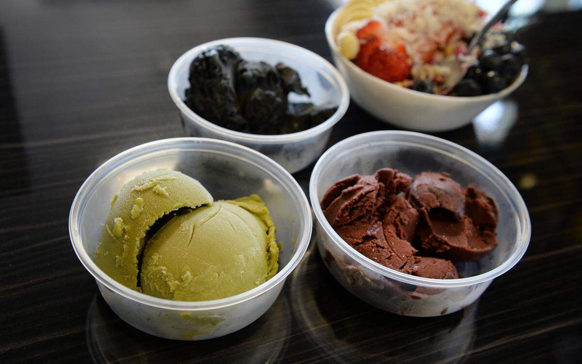 Different sorbet bases for bowls, from left, matcha, charcoal, and acai, are topped with fruit, granola and other toppings at Ohana Pantry in downtown Fresno.