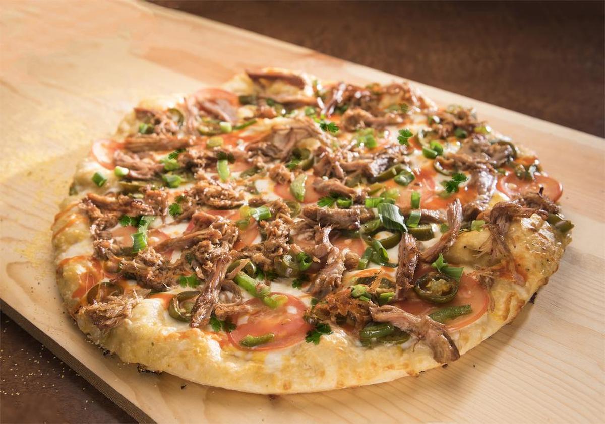 This carnitas pizza at Me-N-Ed's is available year round, even when it's not listed on the menu.