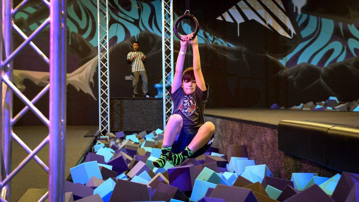 Jayden Eyles, 11, of Roseville ziplines across a bed of foam cubes at Defy Clovis, a new trampoline park that recently opened, on Dec. 28, 2018.