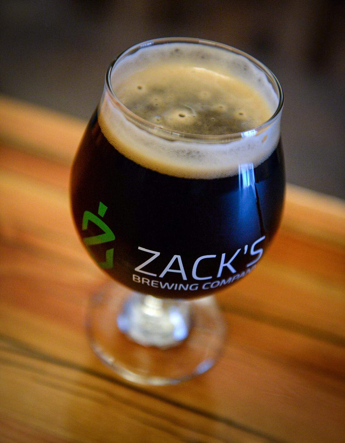 A glass of of It’s All Gouda porter beer made with smoked gouda cheese sits on the bar at the new Zack Brewing in downtown Fresno on Wednesday, Dec. 12, 2018. Zack Brewing will be holding a grand opening on Saturday.