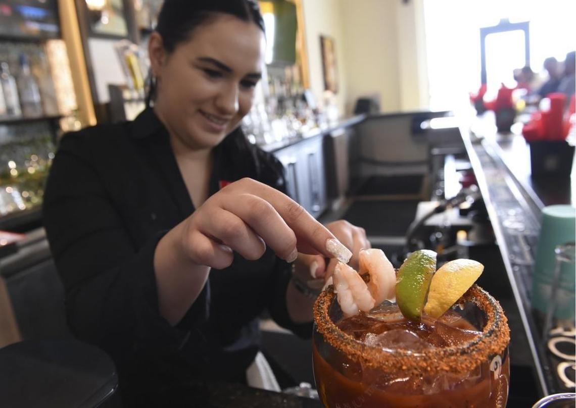 Bartender Alyssa Aguilar creates a Michelada at the newly opened Que Pasa!