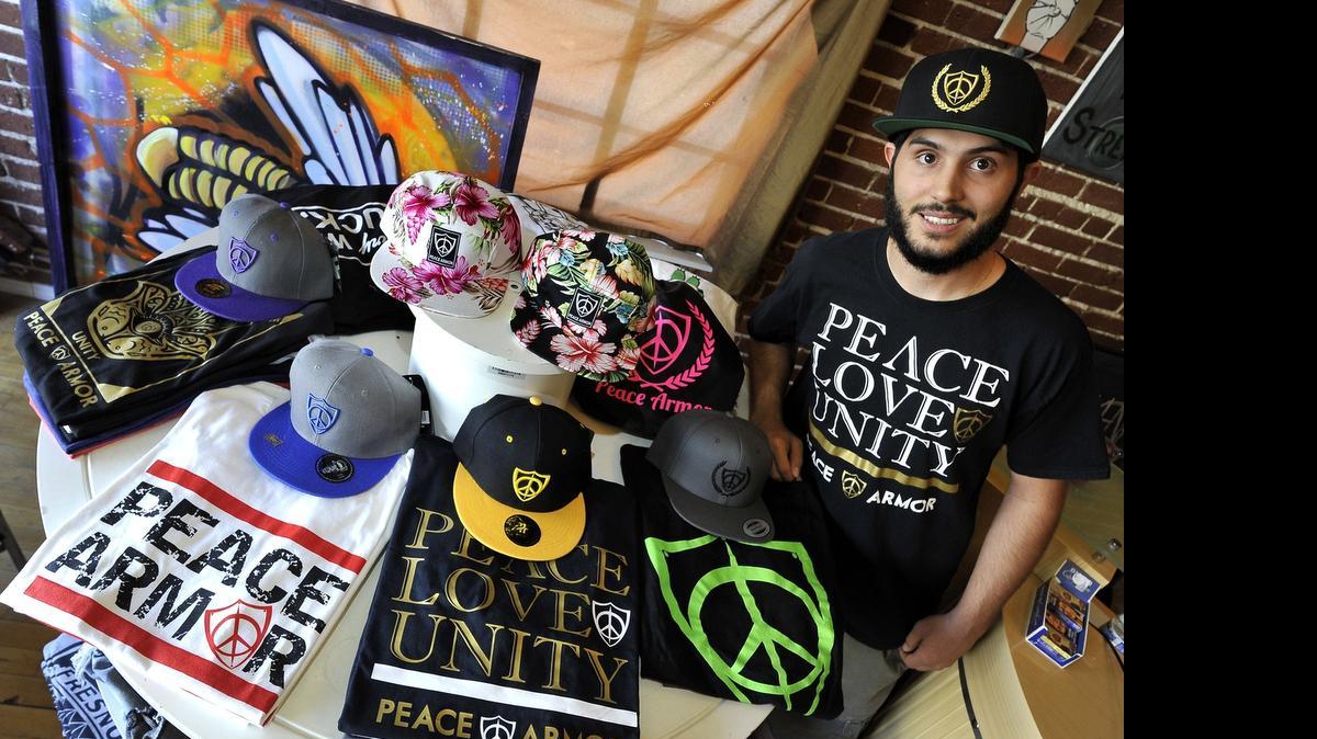 
Mark Rein with some of his Peace Armor merchandise at E’rth World Imports in the Tower District.
