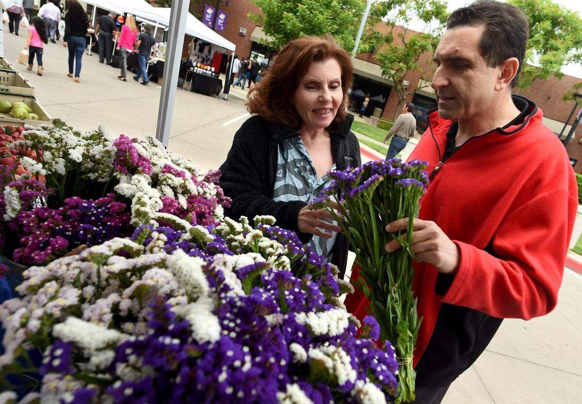 Maro Alpoonarian and Dimitri Jaramishian pick out a bouquet of flowers, at GT Florists and Herbs, at the Market on Kern farmers market in 2017.