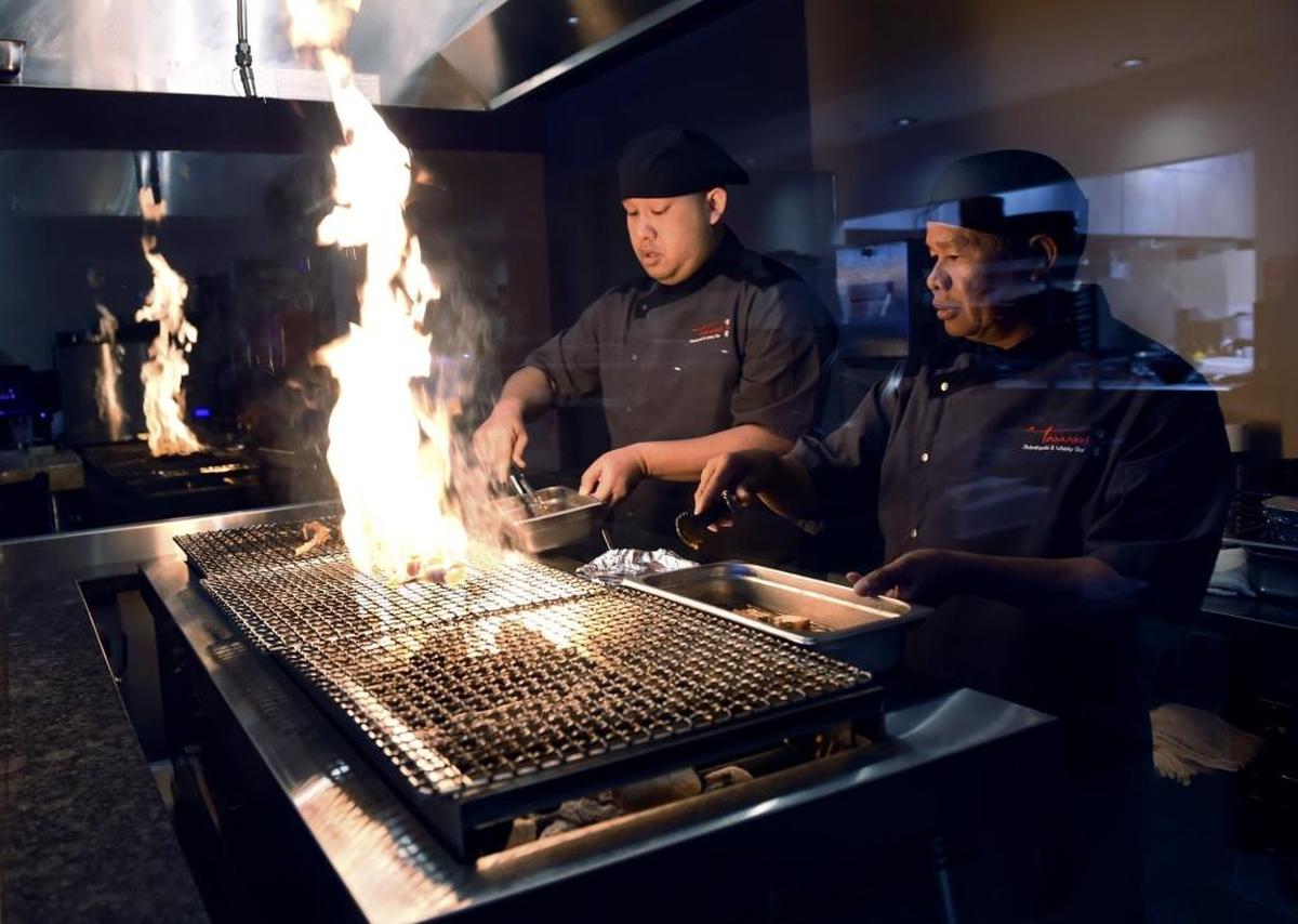 A robatayaki grill, behind glass for patrons to view, is a main feature for grilling food at Tamari Robatayaki & Whiskey Bar which opened recently but will celebrate its grand opening New Year’s Eve. The restaurant specializes in fine whiskey and includes a sushi bar with a contemporary interior accented with shelves, table tops and waiting stools made from walnut and various local Sierra pine trees.