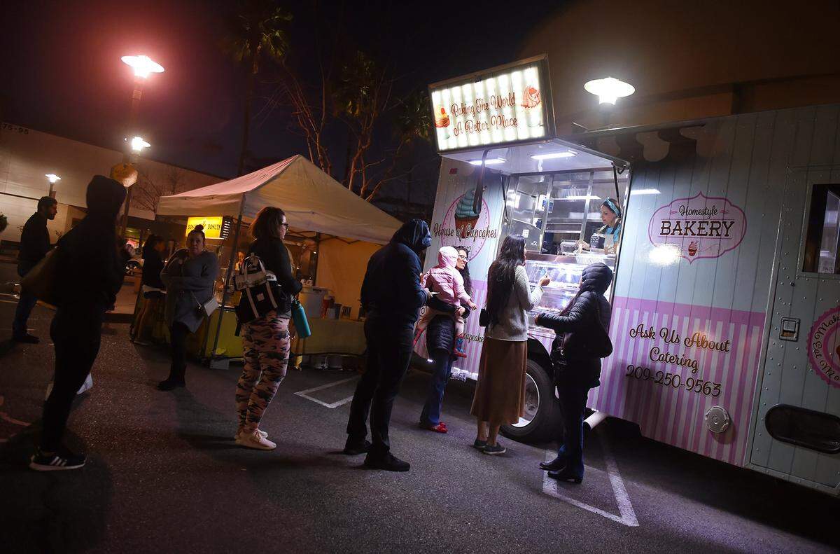 Customers form a line for Haus of Cupcakes during River Park’s farmer’s market Tuesday, Feb. 5, 2019 in Fresno.
