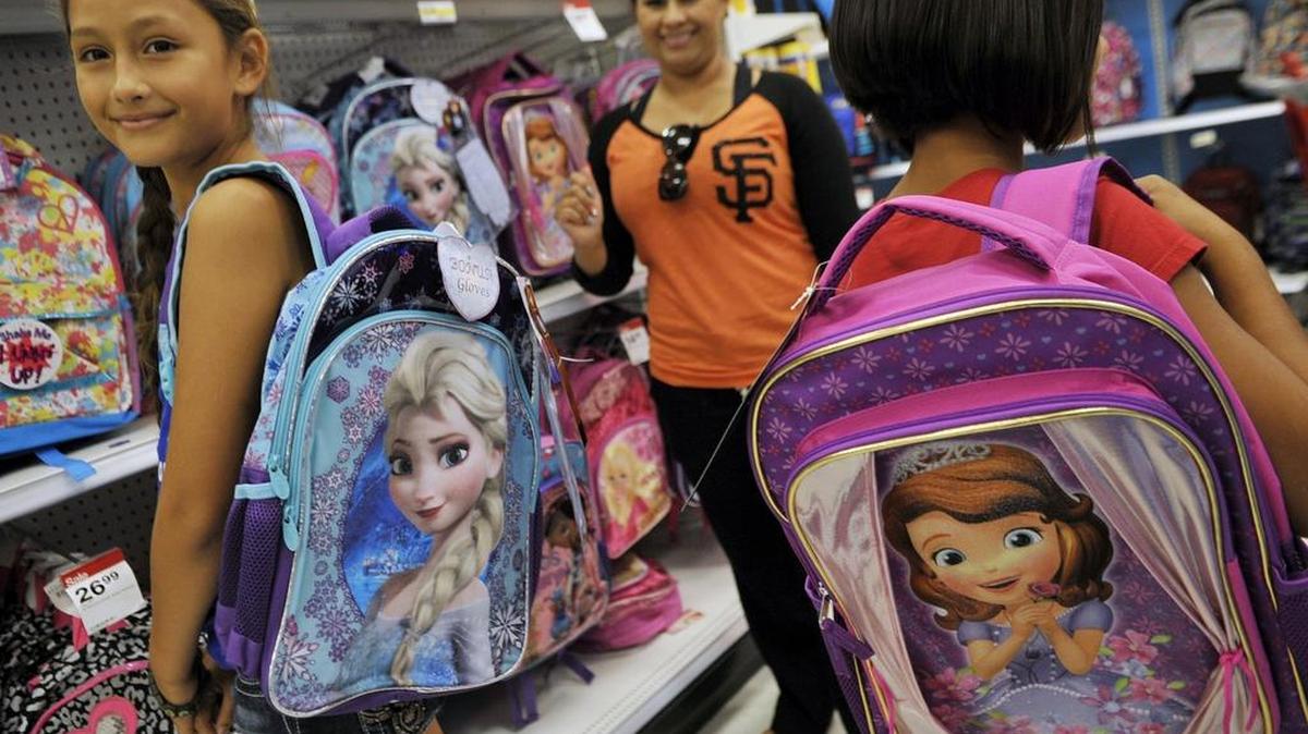 
Firebaugh’s Denise Zavala, 9, left, and her sister Jasmine Zavala, 8, right, model two backpacks while shopping with their mother Miriam Sevilla, center, at El Paseo’s Target in Fresno, Calif.

