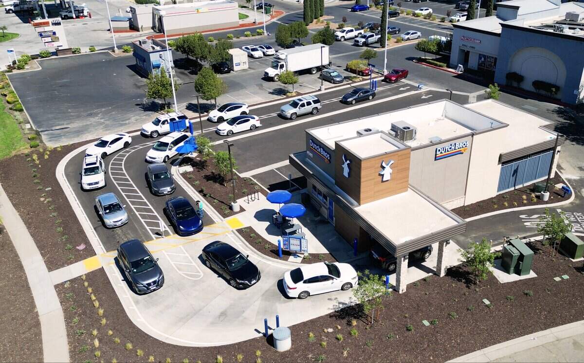 Two Dutch Bros are located 150 feet feet apart at the same southwest corner of Ashlan Avenue and the Chestnut Diagonal, seen Thursday, July 9, 2026 in Fresno. The smaller one at the top left corner is closed and had a single drive-thru lane while the second is new and bigger with two drive-thru lanes.