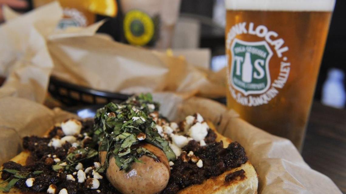 
The Napa Dog, which features a chicken sausage, is served at Rocket Dog Gourmet Brats and Brew, here with a Tioga-Sequoia beer.
