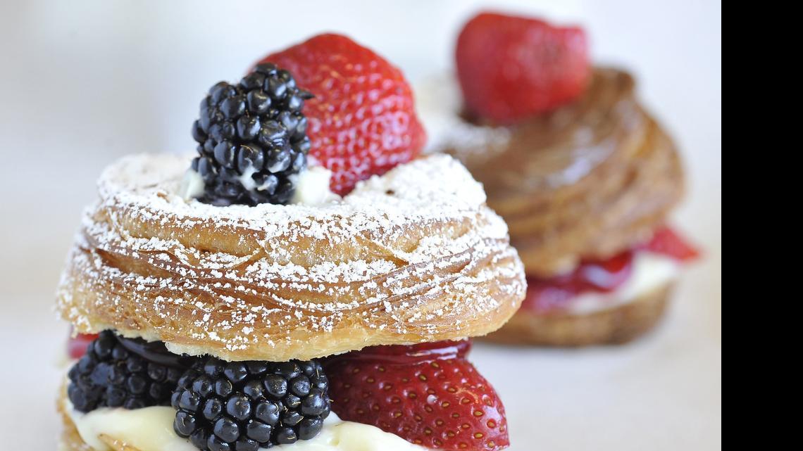 
A cronut with fresh fruit, strawberries, blackberries and Bavarian cream filling at Clovis Donuts. In the background is a cronut with strawberries and Nutella.
