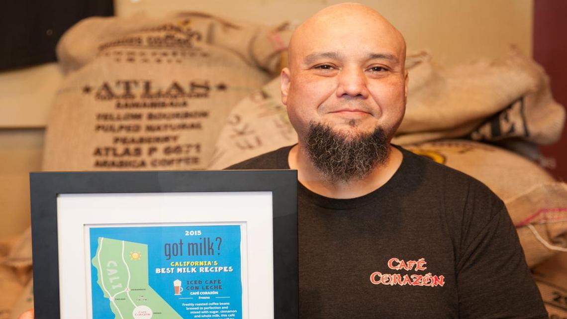 
Leo Rios, owner of Café Corazón in the Tower District, holds a framed version of the California's Best Milk Recipes guide shared on social media by The California Milk Processor Board.
