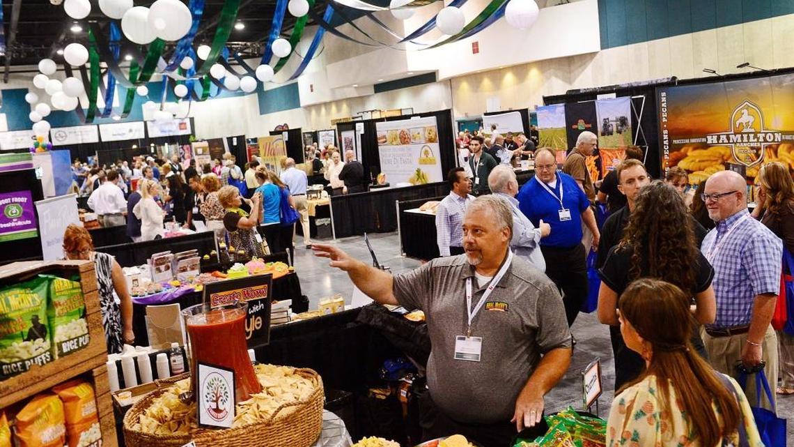 Potential food buyers stop by the Warnock Food Products booth during the 2014 Fresno Food Expo at the Fresno Convention Center.