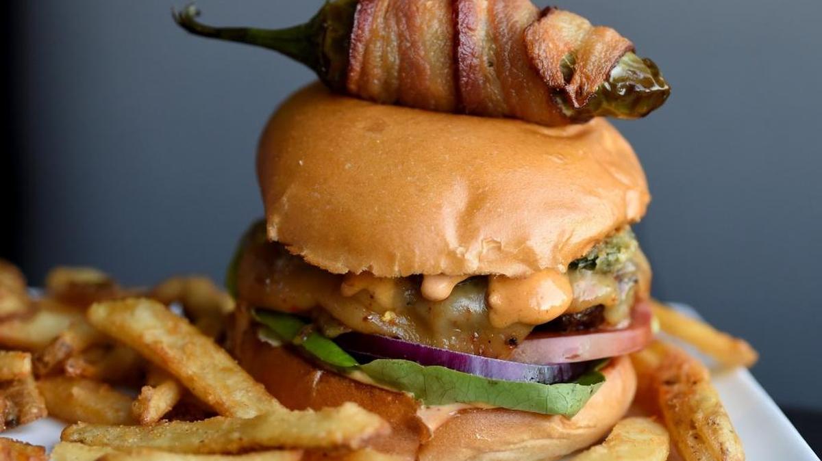 One of the specialty burgers at Colton’s Social House is the Fire House Burger, with ghost pepper cheese, topped with a bacon wrapped pepper.