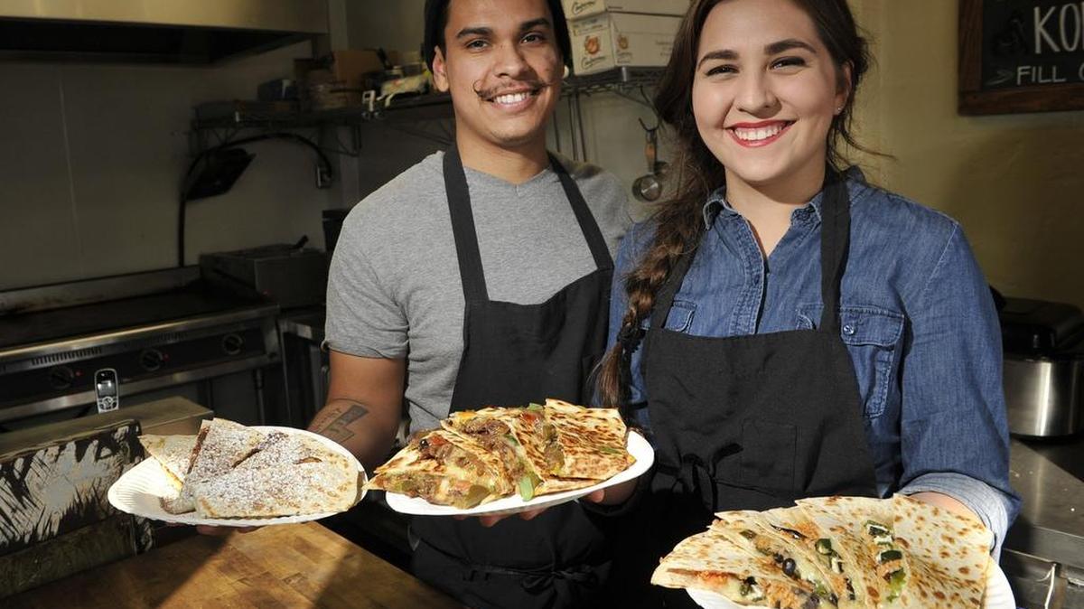 Miguel Reyes, left, and Mikayla Reyes shows three types of quesadillas they offer at Quesadilla Gorilla in Visalia.