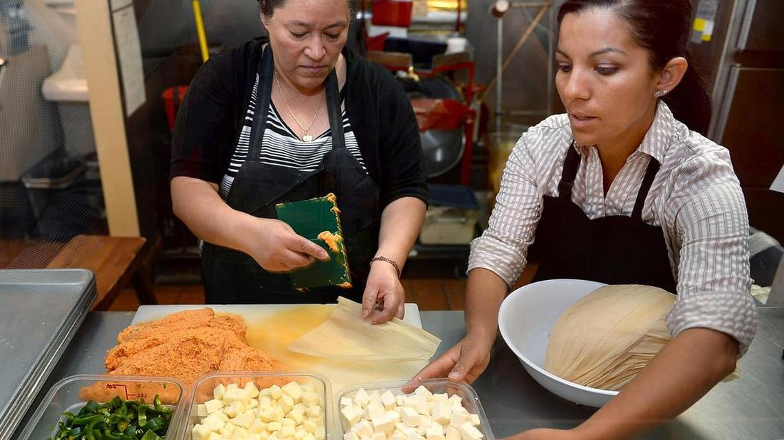 Liz Sanchez, right, prepares tamales with an employee in a summer 2016 photo. Sanchez says she plans to “temporarily pause operations” starting Monday, May 1, 2017, at the Fulton Mall location. At issue is the ability to attract people to the unfinished street and hold outdoor events.