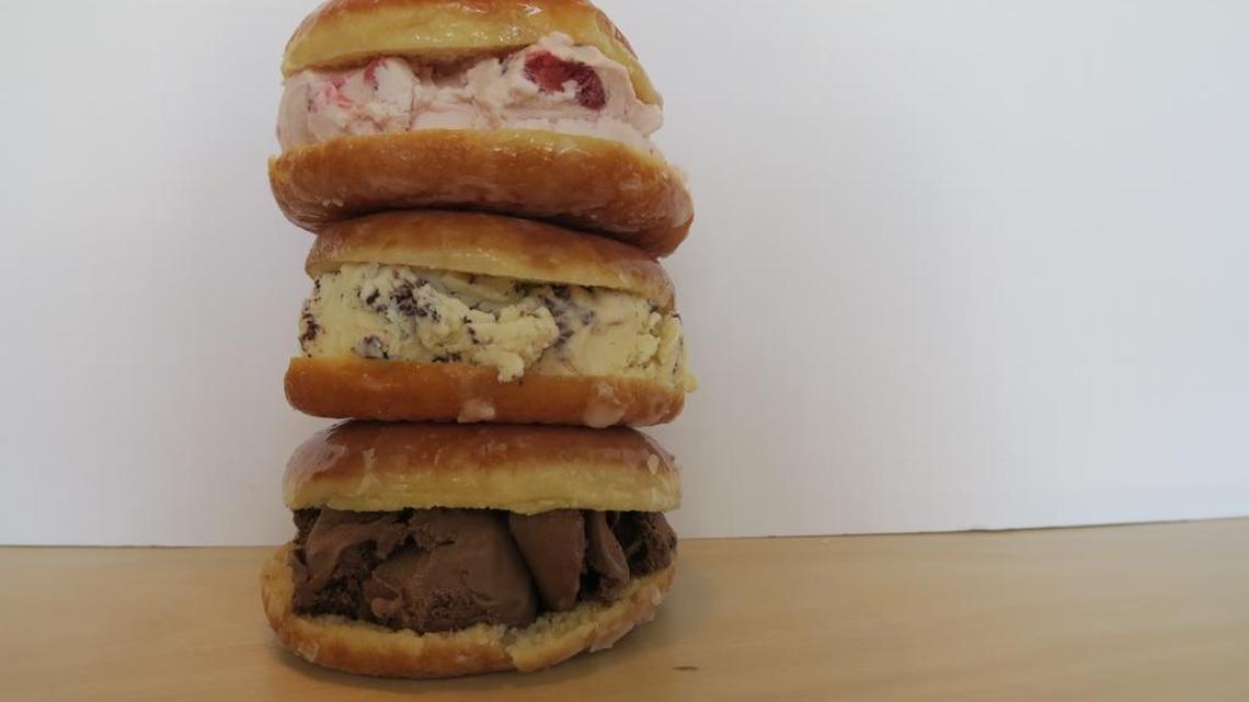 The sweet buns at newly opened G’s Creamery at Bullard and West avenues are glazed donuts filled with ice cream. From top to bottom, the buns hold strawberries and cream; mint chip; and melted chocolate ice cream.