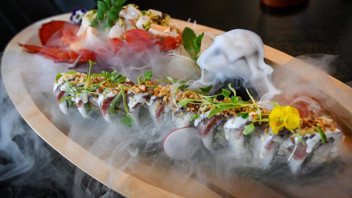 The king of the seas specialty maki is a sushi roll featuring wagyu beef, baked lobster, asparagus, avocado and yuzu aioli paired with a lobster fruit salad. It arrives at your table with dry ice fog flowing out of a serving boat at O-iza Japanese Cuisine in Fresno’s River Park shopping center.