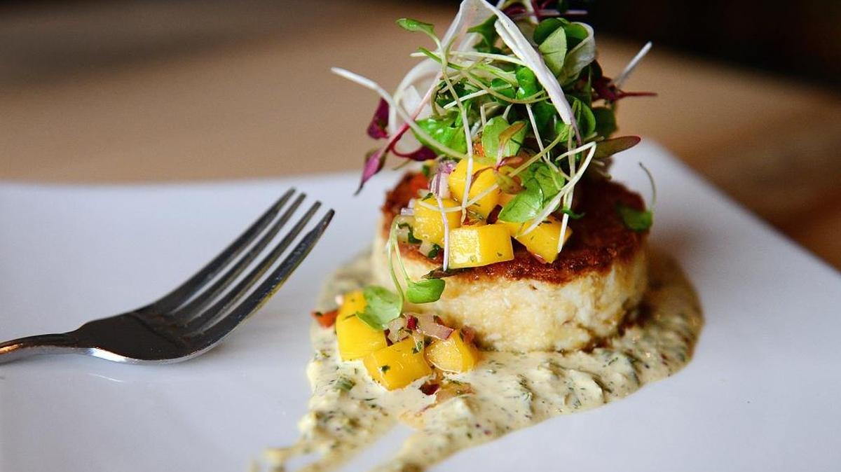 The 3-ounce blue crab cake with jalapeño remoulade and mango salsa is one of the signature appetizers featuring local produce at Trelio in Clovis.