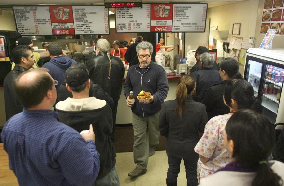 Customers stand in line waiting to order food on Friday at Central Fish.