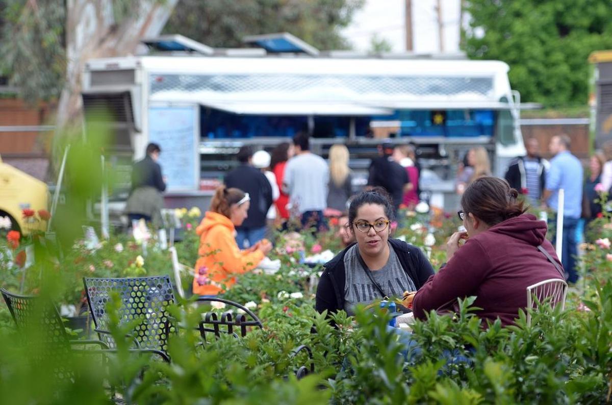 Yvonne Vallejo, 31, of Fresno, enjoys dinner from the food trucks at Gazebo Gardens in Fresno.