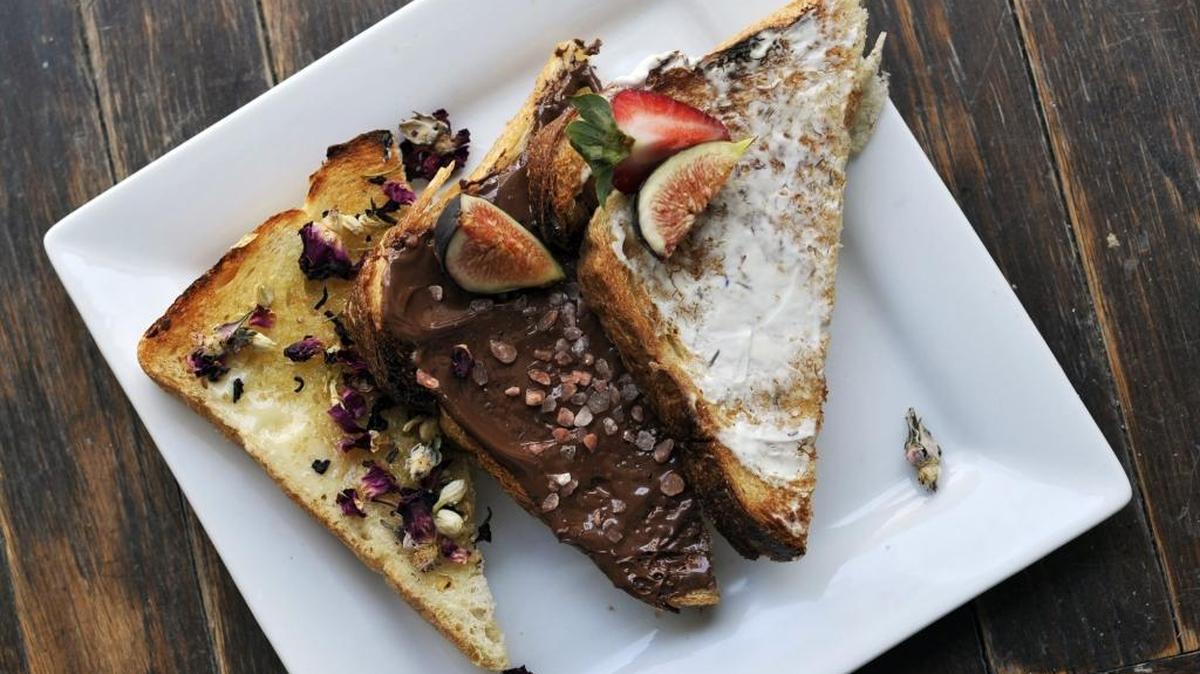 
Raizana Tea Co. serves toast with jasmine, rose and hibiscus, on the left, chocolate and hazelnut with sea salt, middle, and cream cheese, orange peel and blue agave. 
