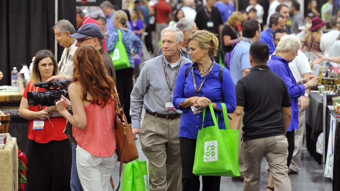 Attendees of the Fresno Food Expo take in the many vendor booths of new food products made in the Valley.