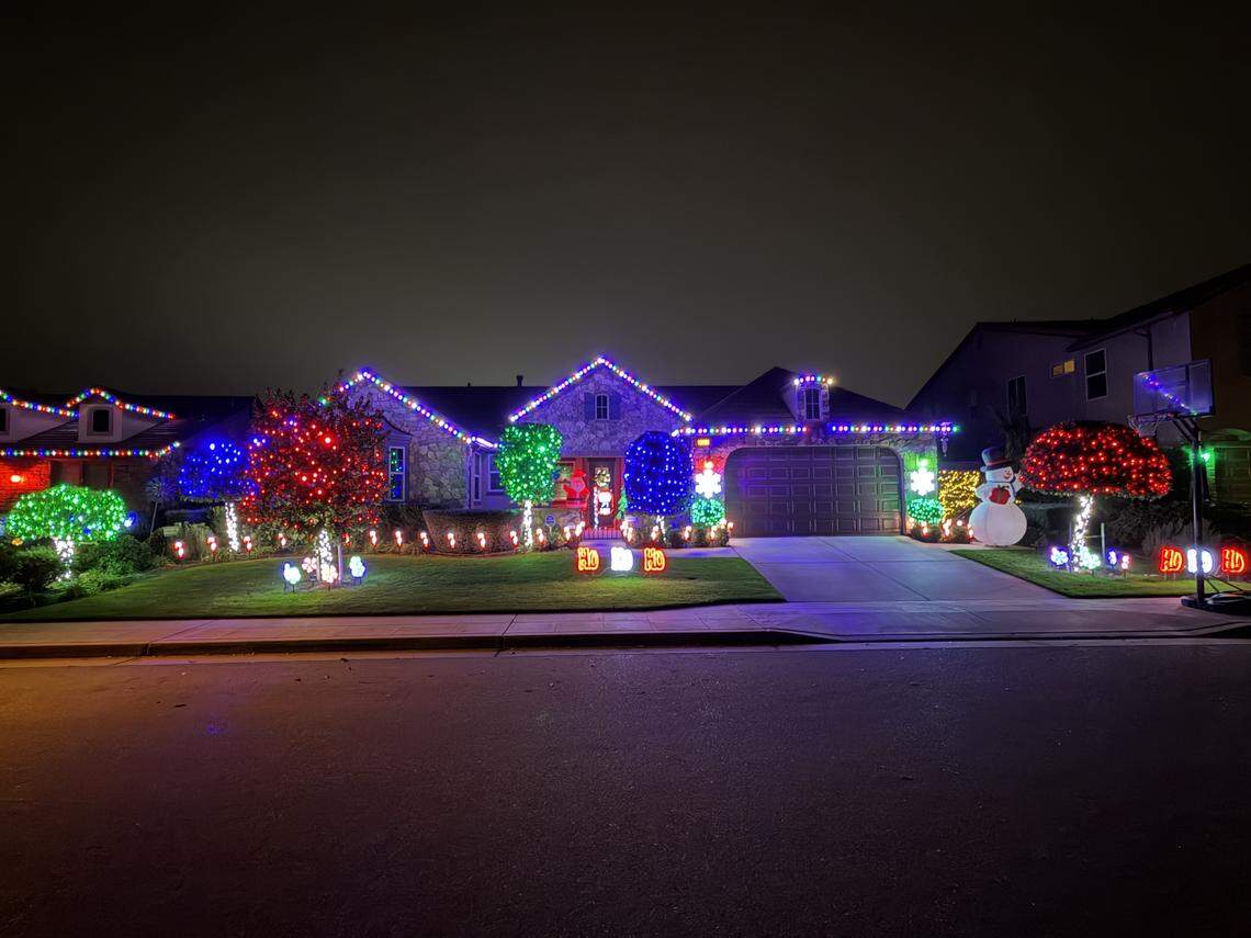Clovis resident Brian Cotta decorates the Clovis home using LED projector lens bulbs that light up a “Lorax”-themed display.