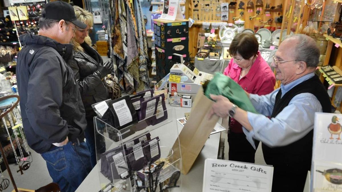 At right, Pat and Larry Grossi sell gifts to Dave Bentley and Valerie Hudson at left at the Bear Creek gift store in Old Town Clovis on Dec. 29, 2012.