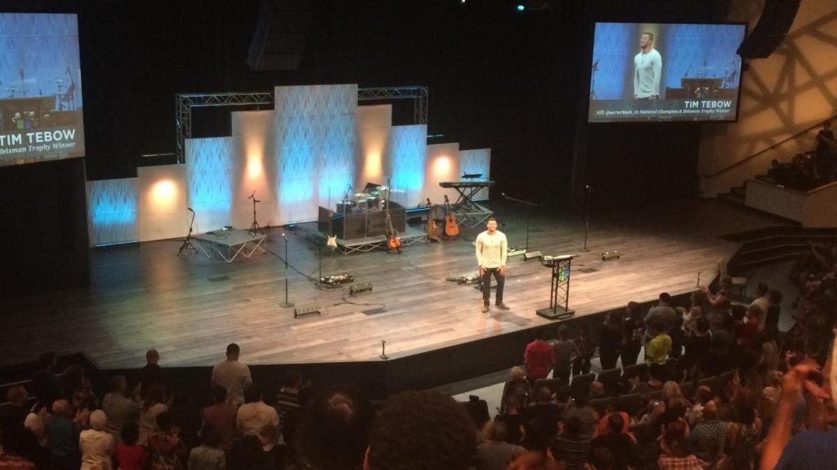 Former NFL quarterback Tim Tebow speaks to around 2,000 people at Northside Christian Church on Saturday night.