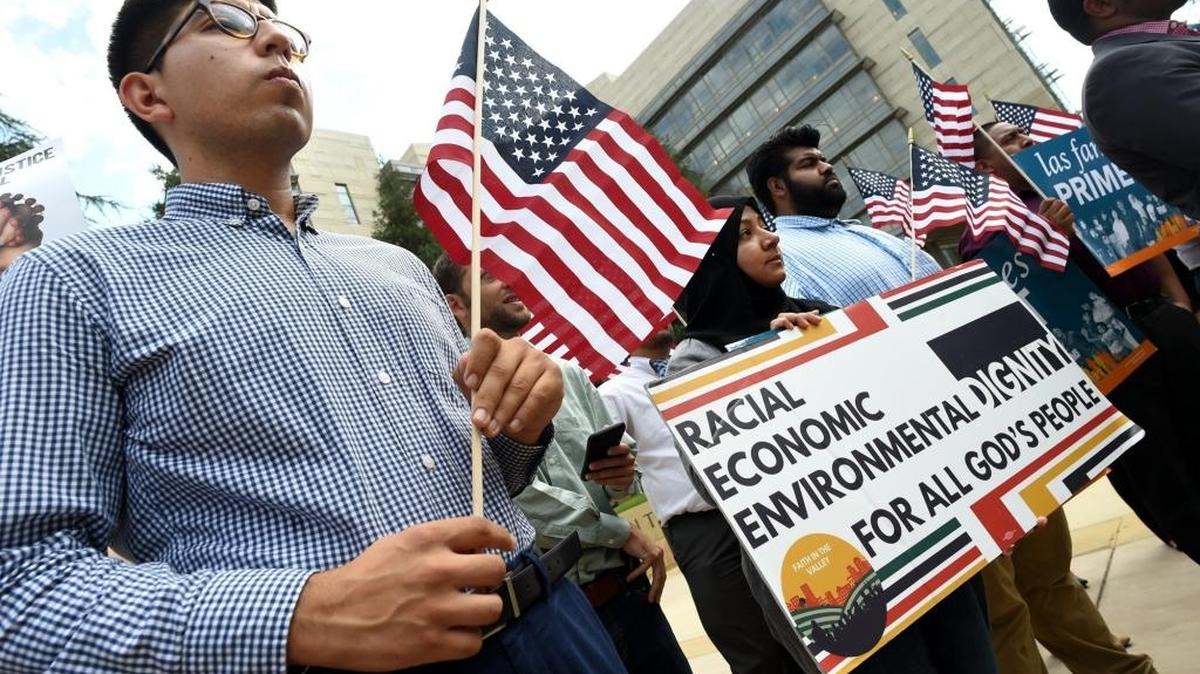 Aaron Andrade, left, joins in a Fresno protest to voice disapproval to the Trump administration’s decision on DACA. The demonstration was held Sept. 5, 2017 in front of the Robert E. Coyle Federal Courthouse in downtown.