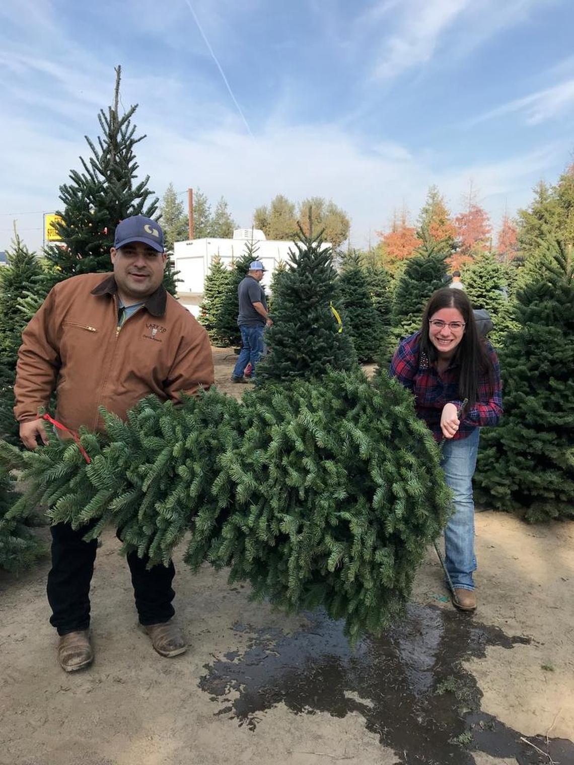 Conrad “Tyler” DiFalco-Jimenez, left, and Morgan Cansler picking out their Christmas tree last year.