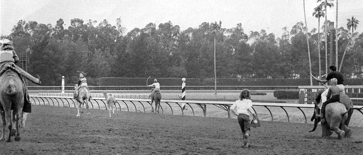 Burrel “Buckshot” Rambo Maier, the small boy at the right, rides a baby elephant in a race at Hollywood Park.