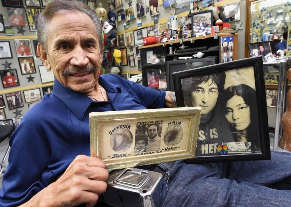 Nick Palomares holds a frame with hair from John Lennon and Yoko Ono.