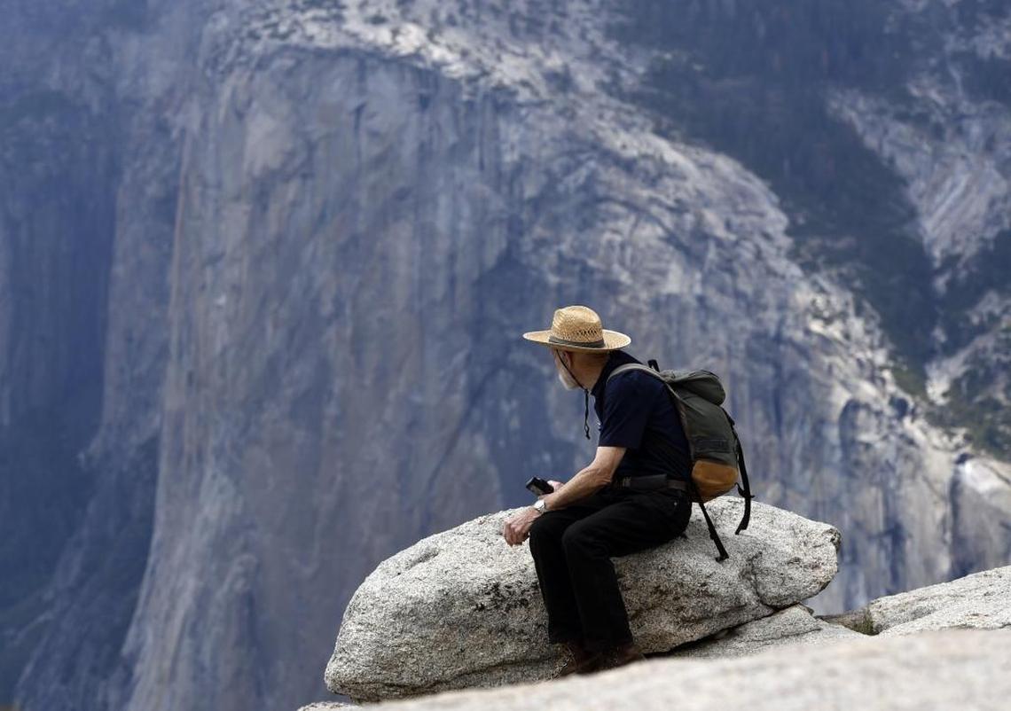 George Whitmore, then 85, who was one of the three men on the first team to climb El Capitan in Yosemite Valley, looks out from Taft Point during a short hike May 26, 2016 in Yosemite National Park. El Capitan is in the background across Yosemite Valley. The first El Cap climb, which culminated in November of 1958, remains one of the major feats in climbing history.