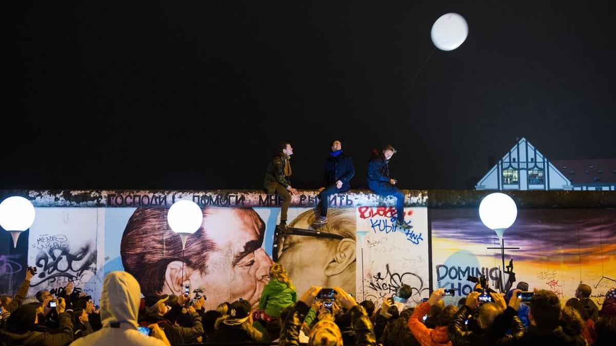 
In this file photo, balloons of the art installation “Lichtgrenze 2014” (“light border 2014”) fly away at the East Side Gallery, a remnant of the Berlin Wall, in Berlin Sunday, Nov. 9, 2014. It was on Nov. 9, 1989 the East-German government lifted travel restrictions and thousands of East Berliners had pushed their way past perplexed border guards to celebrate freedom with their brethren in the West. 
