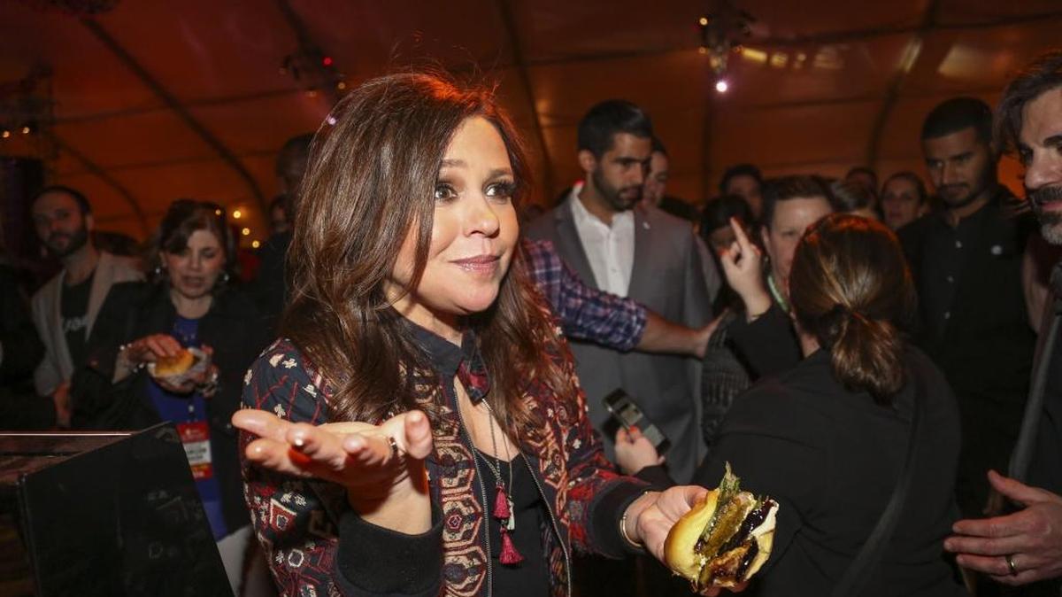 Rachael Ray enjoys a burger made by Chef Eden Grinshpan at the 2016 South Beach Wine & Food Festival on Friday, Feb. 26, 2016. Her “The Book of Burger” cookbook is available at the Fresno County Library.