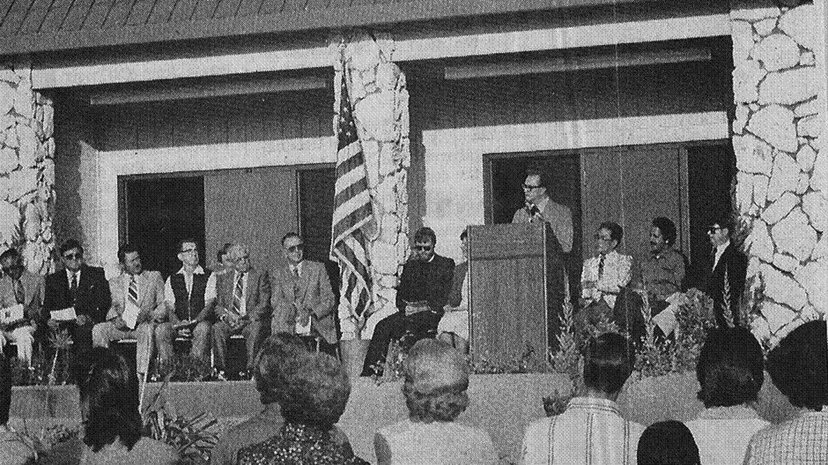 Enterprise File Early in the second decade of the Los Banos Campus of Merced College (1982), a grand opening was held at the campus’s new facility on Mercey Springs Road. Bill Martineson, then president of the college, is at the microphone. Richard Rodoni, who served then as the college trustee from the district’s Westside, is third from the left on stage. Richard Menezes, who donated the land for the Mercey Springs site, is second from the right on stage.