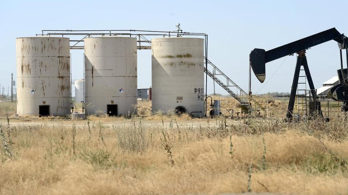 An oil pump jack and tanks are visible off the road just outside of Riverdale. Scattered throughout the agricultural fields of Fresno County are thousands of oil and gas wells producing millions of barrels of crude oil and billions of cubic feet of gas each year.
