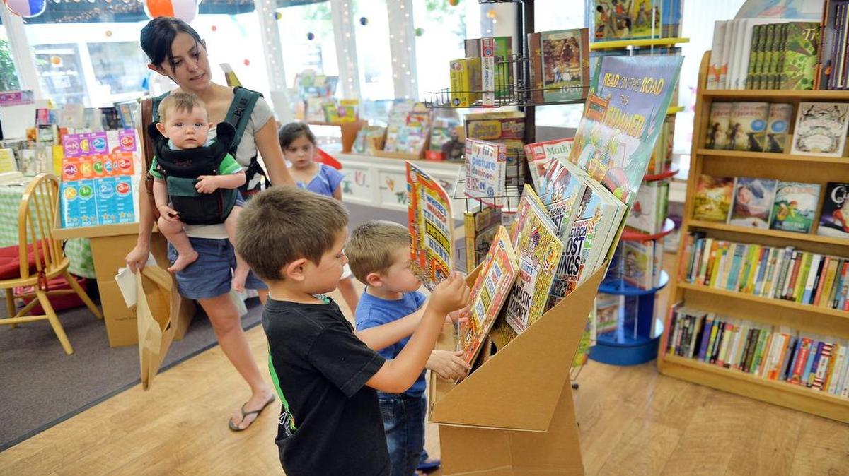 
Erika Reinhold, of Fresno, shops for books with her children inside Petunia's Place on North Palm Avenue in Fresno.
