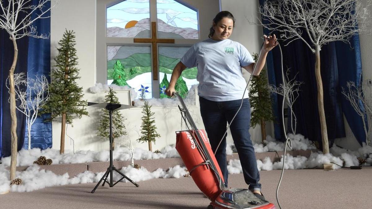 Victoria Rocha of 5 Gals Cleaning vacuums inside the Cornelia Southern Baptist in Fresno Thursday.