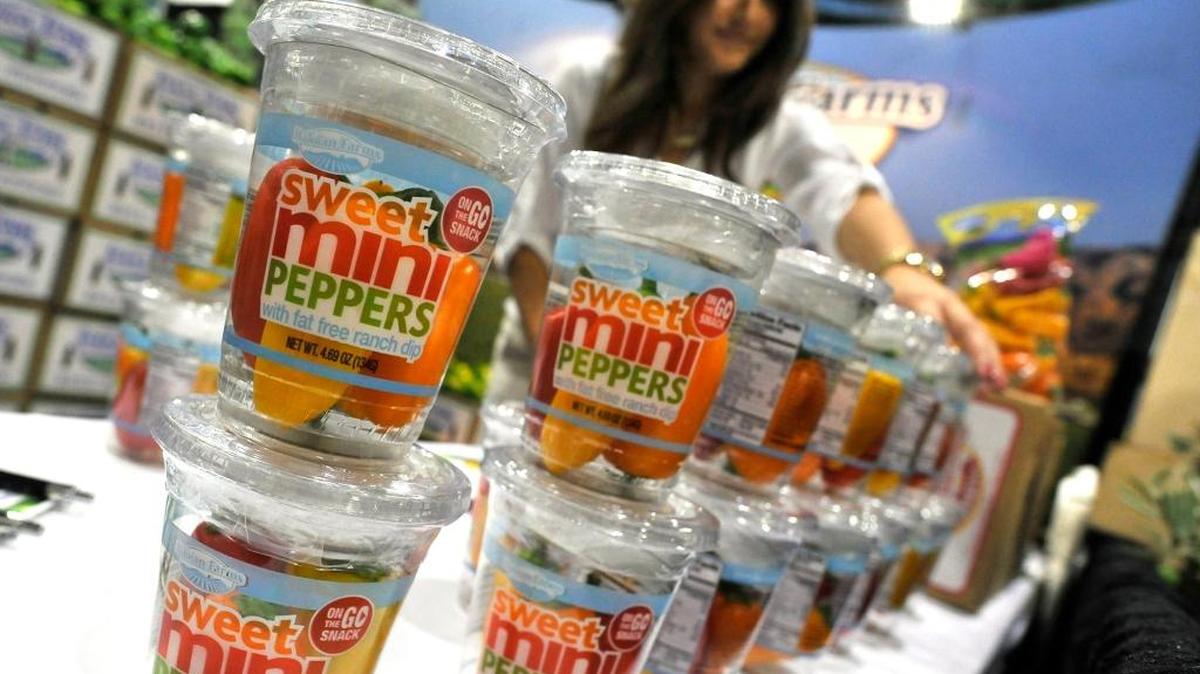 Sierra Lopes of Baloian Farms puts out a new product, cups of Sweet Mini Peppers, during the fifth annual Fresno Food Expo last July, 2015.