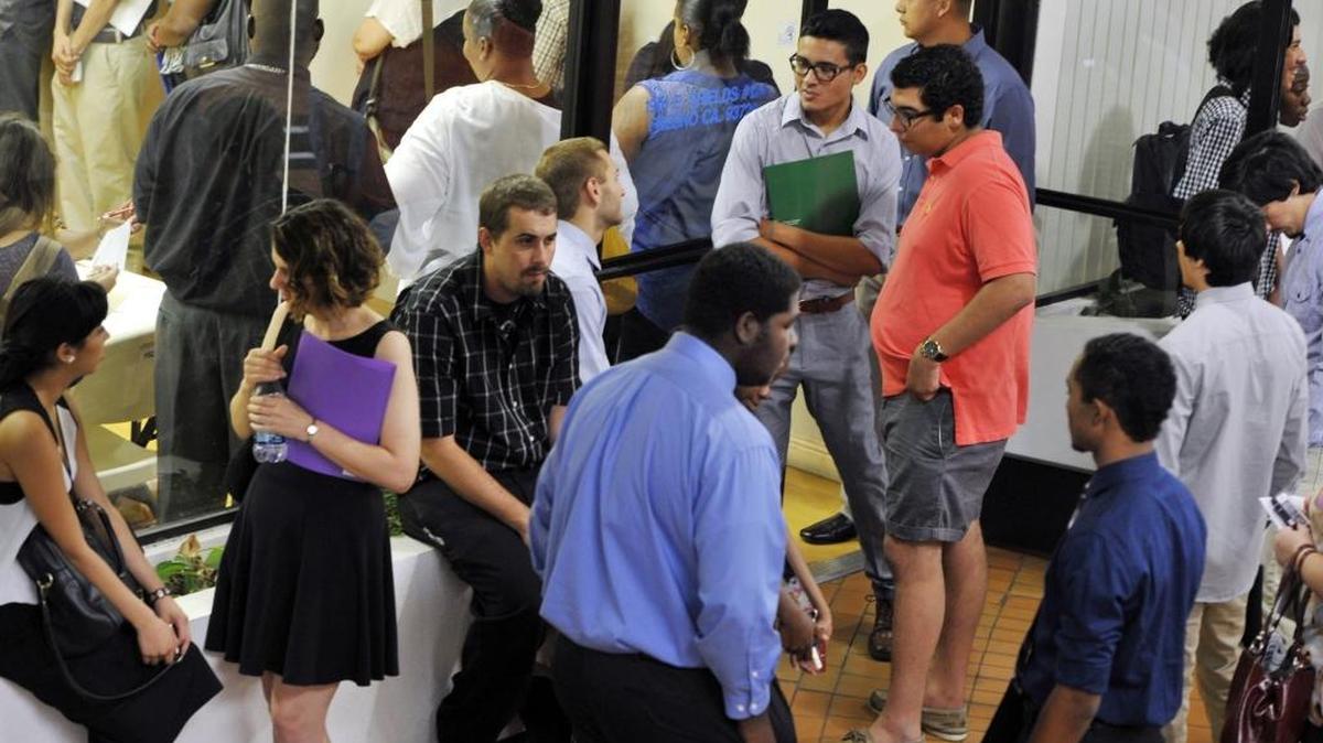 Applicants enter a small office at a job fair held for Smart & Final at Manchester Center Thursday, Aug. 13, 2015 in Fresno.